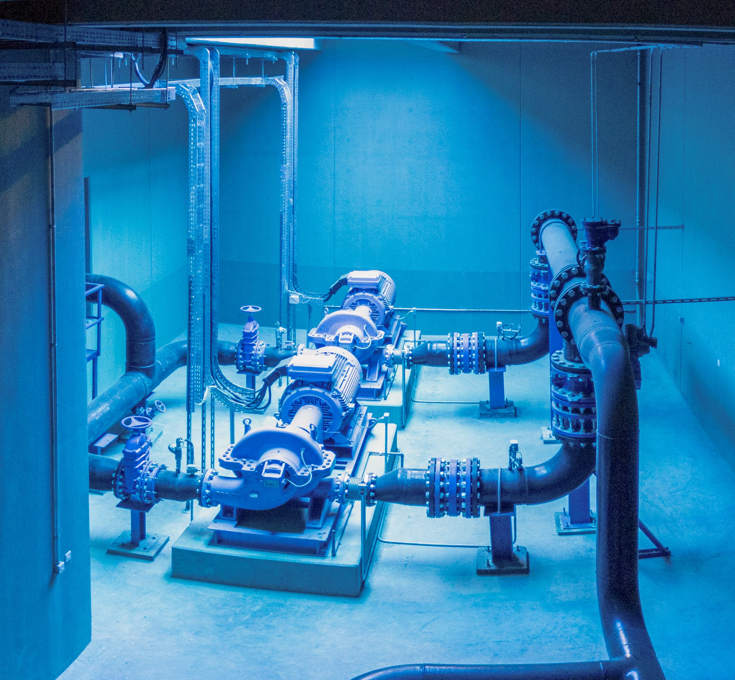 Large pump station interior showing rows of industrial pumps